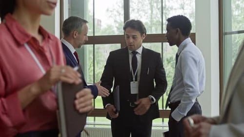 Friendly Business People Networking at a Conference