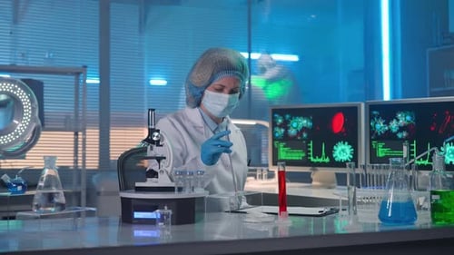 Scientist Analyzing Samples Under Microscope in a Laboratory