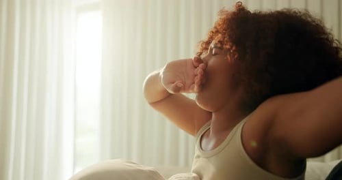 Woman Waking and Stretching in Bed, Close Up
