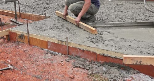 Leveling Concrete By Using Special Tool By a Construction Worker