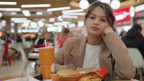 White Teen Girl Striking Confident Pose with Chin Up at Food Court Stylish Blazer Bold Gaze Attitude