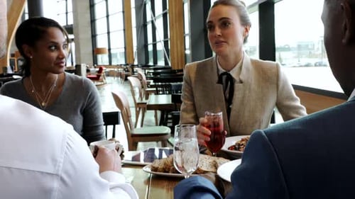Business lunch at restaurant with team using digital tablet and wireless technology