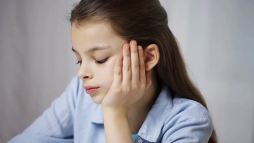 Education, People, Children and Learning Concept - Bored School Girl with Books