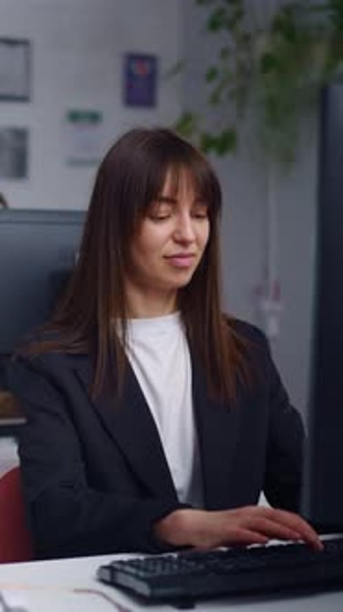 Focused Female Professionals Working at Modern Office Desks Using Desktop Computers Concentrating on