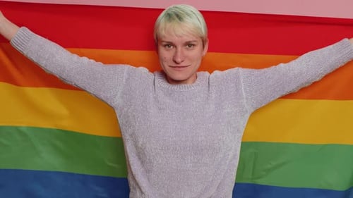 Adult Smiles with Rainbow Pride Flag