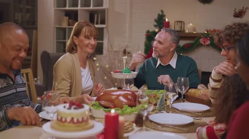 Diverse Family Gathered at Table for Holiday Meal