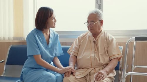 Healthcare Worker Holding Hand of Senior Patient
