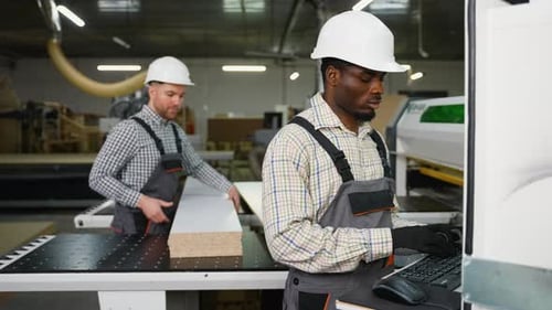 Team Operating CNC Machine to Cut Furniture Panels