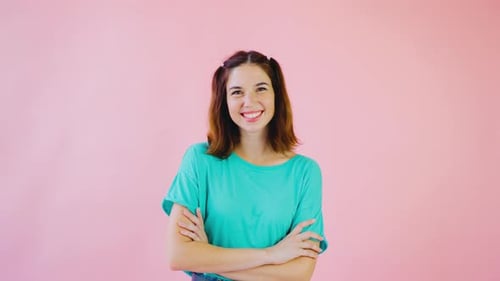 Smiling Woman Posing in Studio with Pink Backdrop