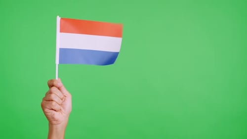 Hand Holding Orange, White, and Blue Flag
