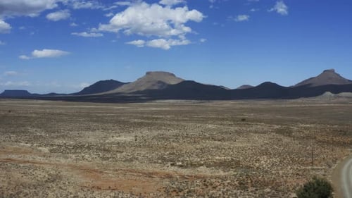 Earthy tones with a blue sky in a dry and harsh environment. Aerial view of the Karoo desert, in Sou