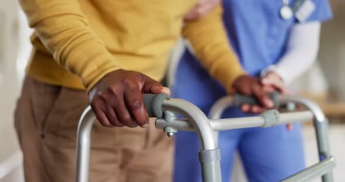 Person Using Walker with Healthcare Worker Assistance