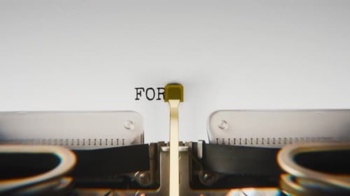 Old mechanical typewriter typing Forgiveness in a close-up view.