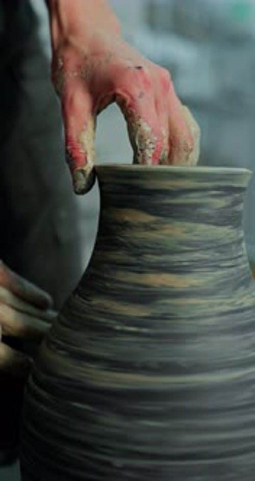 Potter Shaping Clay on a Spinning Wheel
