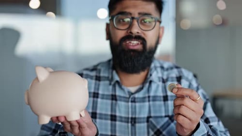 Bearded Man Saving Money in Piggy Bank at Office