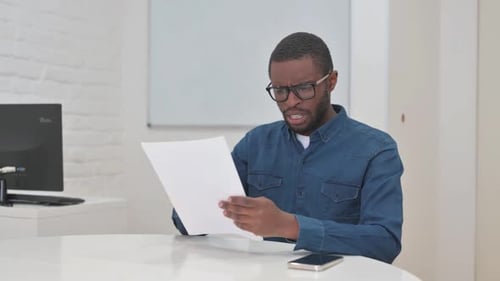 Young Adult Upset by Document Review in Office