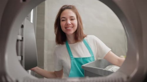 Woman Putting Clothes in Washing Machine
