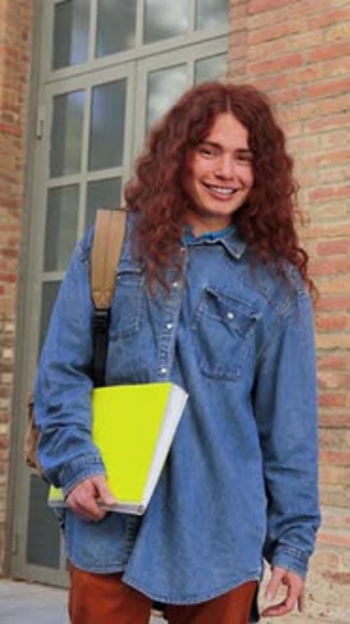 Vertical Footage of a Optimistic Student Standing and Looking at Camera at University Campus