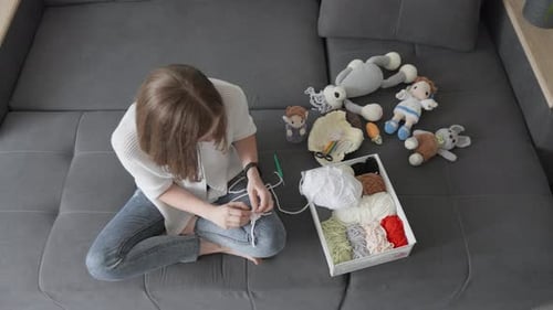 A Woman Diligently Knits Amigurumi Making Each Loop of Yarn Accurate Creating Works of Art That Will