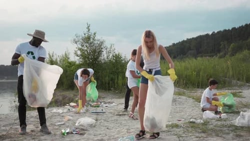 Volunteers Cleaning Up Trash On Sandy Beach