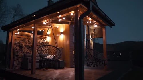Inviting Patio with Hanging Chairs at Night