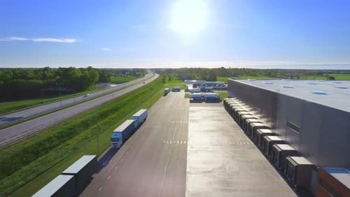 Aerial View Footage of Loading Warehouse with Semi Trucks Parked and Waiting for Loading. Big Indus