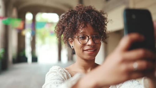 Woman Takes Selfie in an Urban Walkway