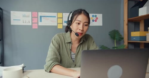 Woman at Computer Participating in Video Conference