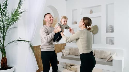 Happy Family Playing with Baby in Home