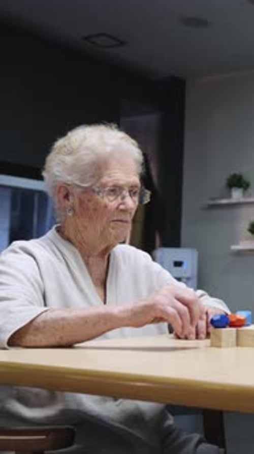 Elderly Woman Playing with Colorful Toys in Slow Motion