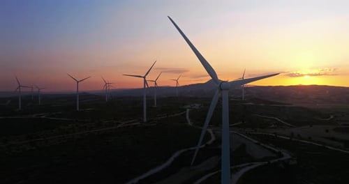 Aerial View of the Silhouette of a Wind Farm at Sunset