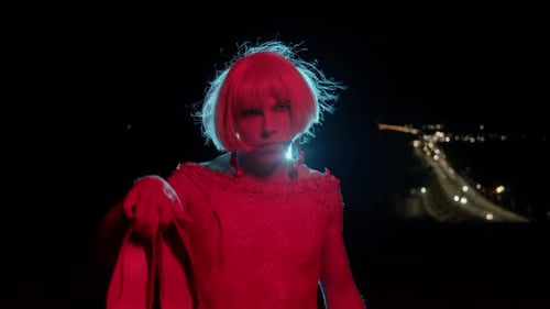 Woman Holds Red Shoes at Night, Red and Blue Lighting