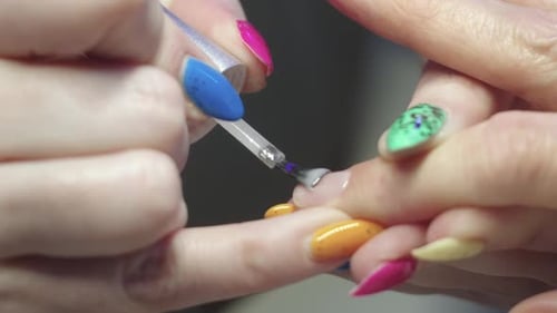 Manicure Applying the Base on the Nail of the Finger
