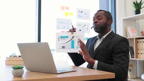 African Entrepreneur Using Laptop for Video Call at Office
