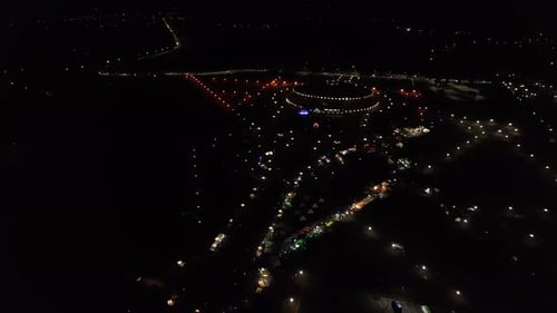 Stunning Aerial View of Nightlife of City During Holiday with Trade and Concert in Square Near Round
