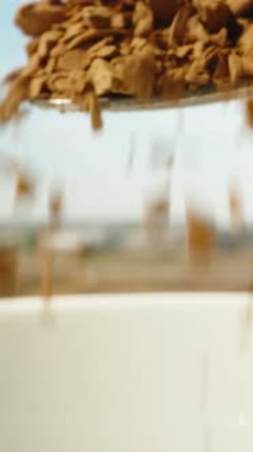 Instant coffee is sprinkled in a white mug against the blue sky. Dolly slider extreme close-up. Laow