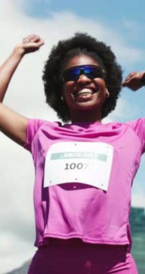 Female Athlete Celebrates Race Victory Outdoors in Sunlight