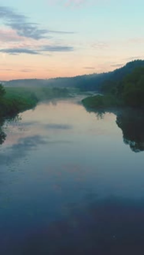 Flying Forward Over River in Mist at Sunrise Green Trees and Meadow Vertical Video