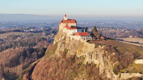 Aerial view of medieval fortress and vineyards in autumn, Austria.