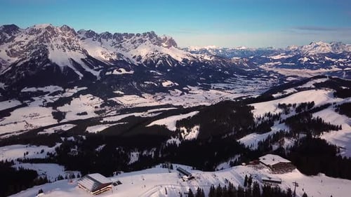 Winter Aerial View of Snowy Mountains and Ski Resort