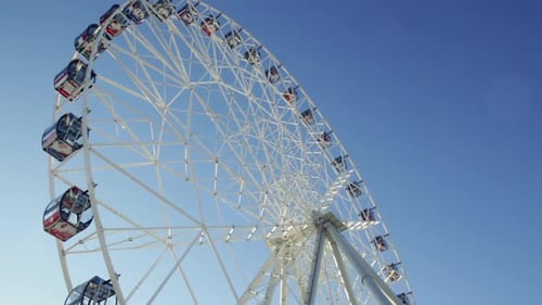 Ferris Wheel Spinning Against Blue Sky