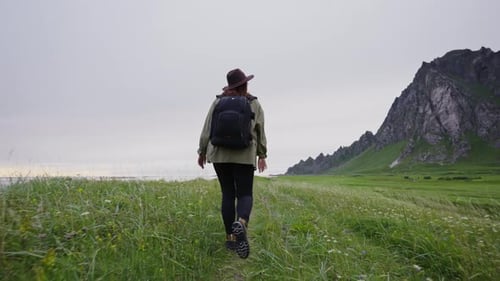 Traveler Girl Dressed in a Hat a Green Jacket and Backpack She Walks Along the Coast of the
