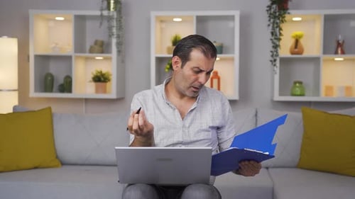 Man Working From Home Reviewing Documents