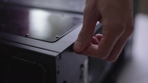 Hand Unscrewing Computer Case Close Up