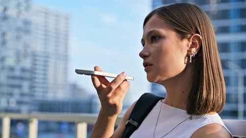 Woman Using Voice Command on Phone in City
