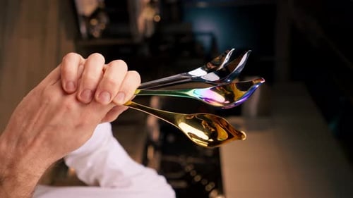 Chef Holding Decorative Spoons for Food Presentation