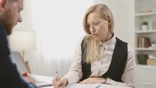 Businesswoman Meeting in Bright Office with Client