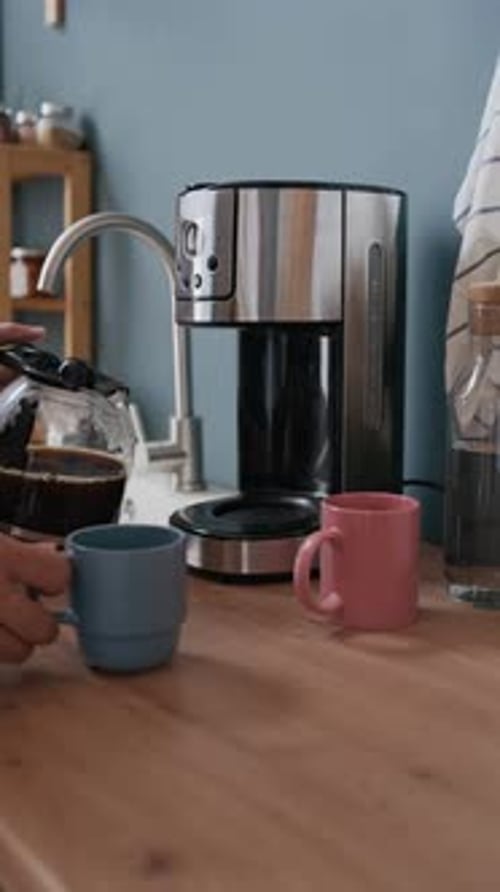 Man Pouring Fresh Coffee in Modern Kitchen