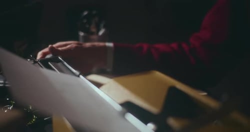 Man Types on Vintage Yellow Typewriter Close Up