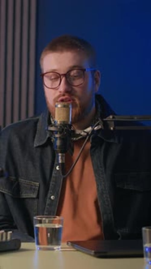 Man Talking Into a Microphone in a Studio